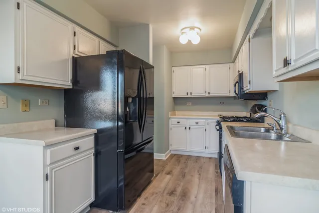 a kitchen with cabinets stainless steel appliances and a counter space