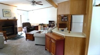 41 Pipers Way Carver, MA 02330 - Photo 8 of 36 a living room with furniture a flat screen tv and a fireplace