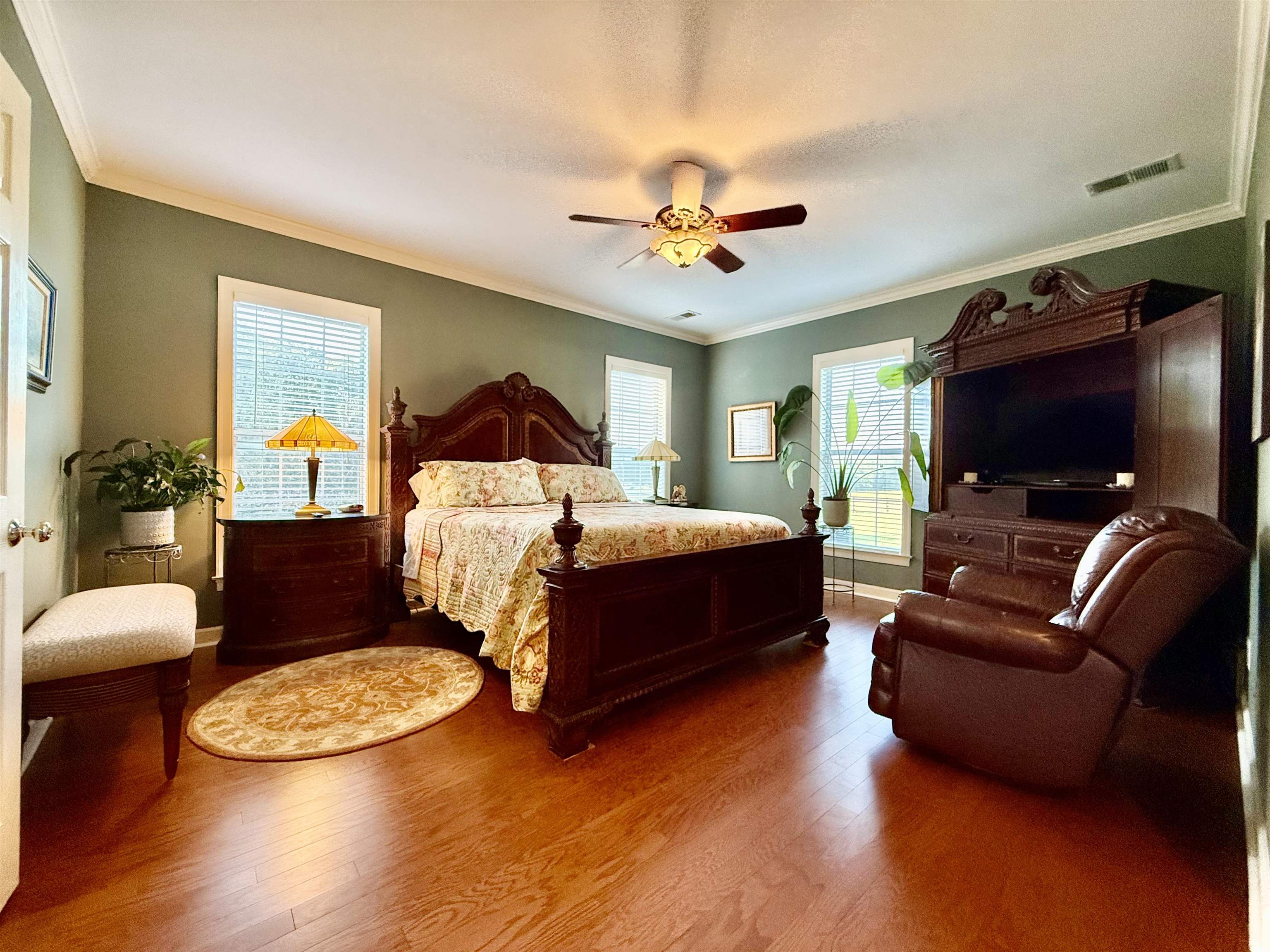 705 Old Solomon Mill Road Somerville, TN 38068 - Photo 17 of 40 a bedroom with a bed a couch and a chandelier