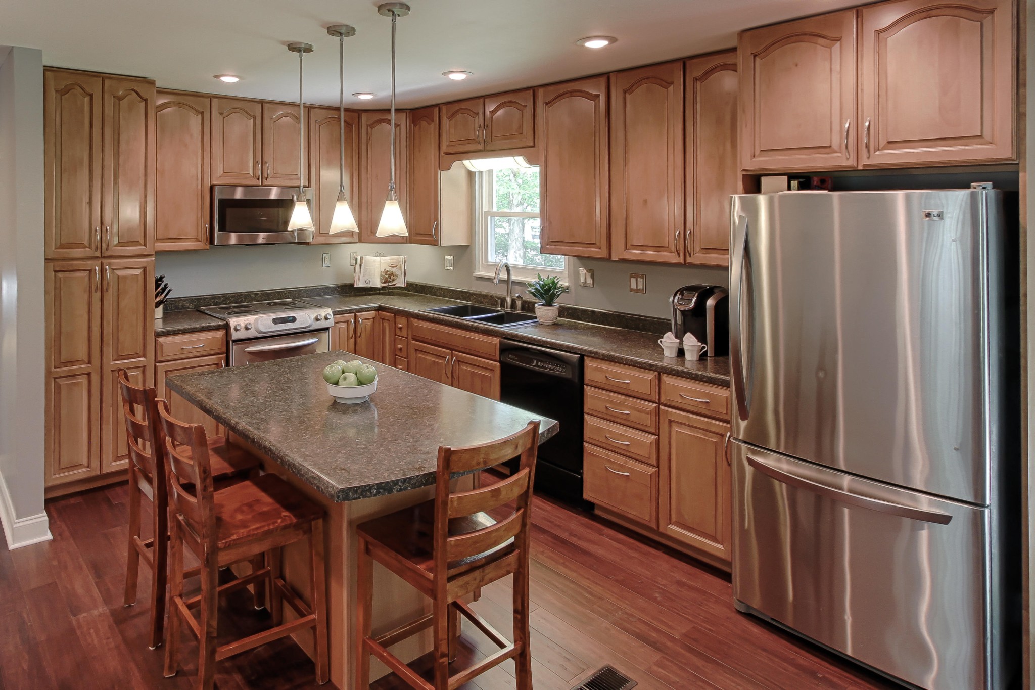 128 Culver Road Oak Ridge, TN 37830 - Photo 3 of 14 a kitchen with stainless steel appliances granite countertop a refrigerator a stove a sink a microwave and island with wooden floor
