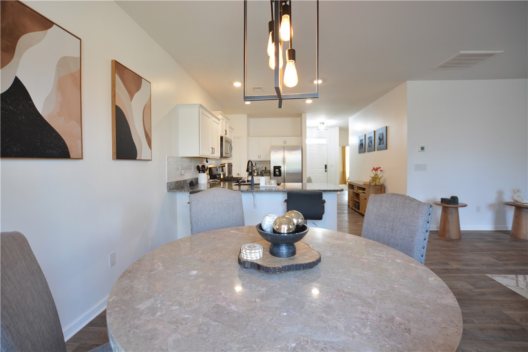 242 Hillendale Way Pelzer, SC 29669 - Photo 11 of 19 This inviting space combines elegant dining with a well-appointed kitchen, perfect for everyday living.