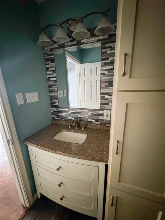 702 Jefferson Street Alice, TX 78332 - Photo 13 of 38 a bathroom with a granite countertop sink and a mirror