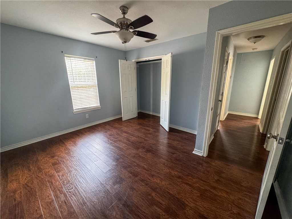 702 Jefferson Street Alice, TX 78332 - Photo 22 of 38 a view of a livingroom with wooden floor and a ceiling fan