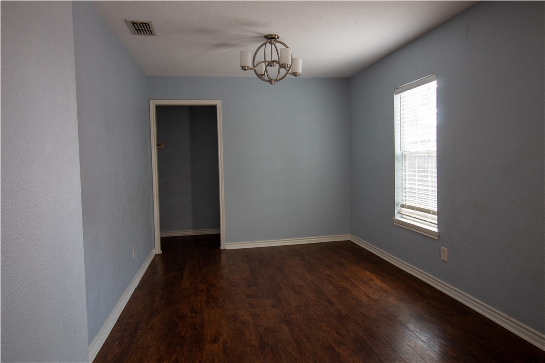 702 Jefferson Street Alice, TX 78332 - Photo 26 of 38 a view of an empty room with wooden floor and a window