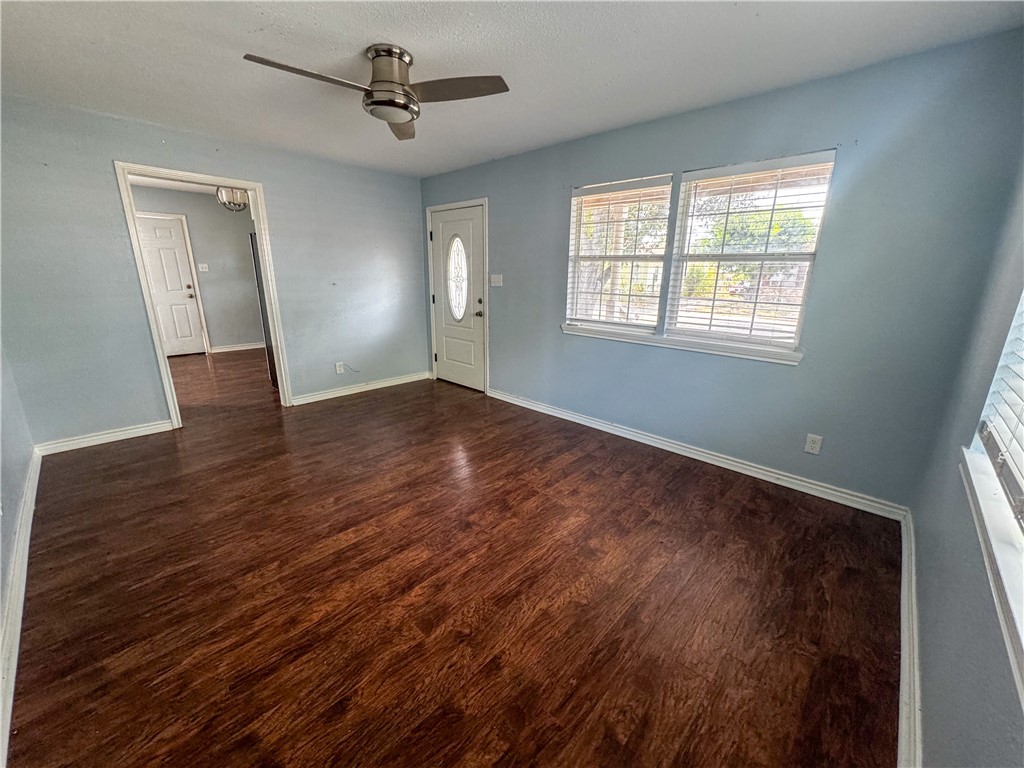 702 Jefferson Street Alice, TX 78332 - Photo 28 of 38 an empty room with wooden floor and windows