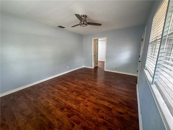 wooden floor in an empty room with a window