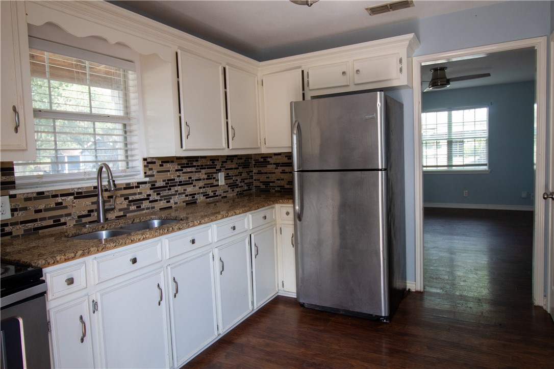 702 Jefferson Street Alice, TX 78332 - Photo 10 of 38 a kitchen with stainless steel appliances a refrigerator sink and cabinets