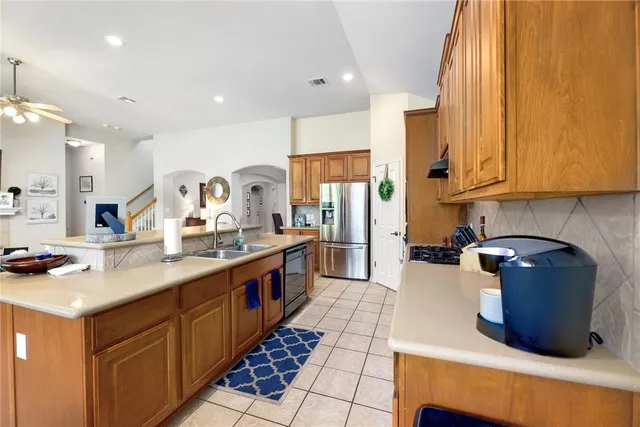 a kitchen with stainless steel appliances granite countertop a sink stove and cabinets