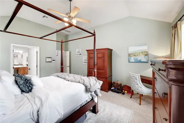 a bedroom with a bed a desk and chair