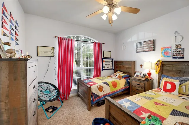 a bedroom with two beds and a chandelier