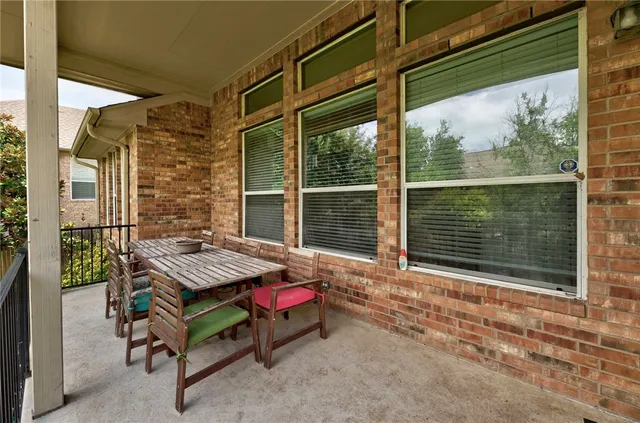 a backyard of a house with a table and chairs
