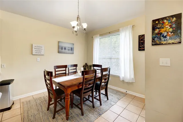 a view of a dining room with furniture and a chandelier