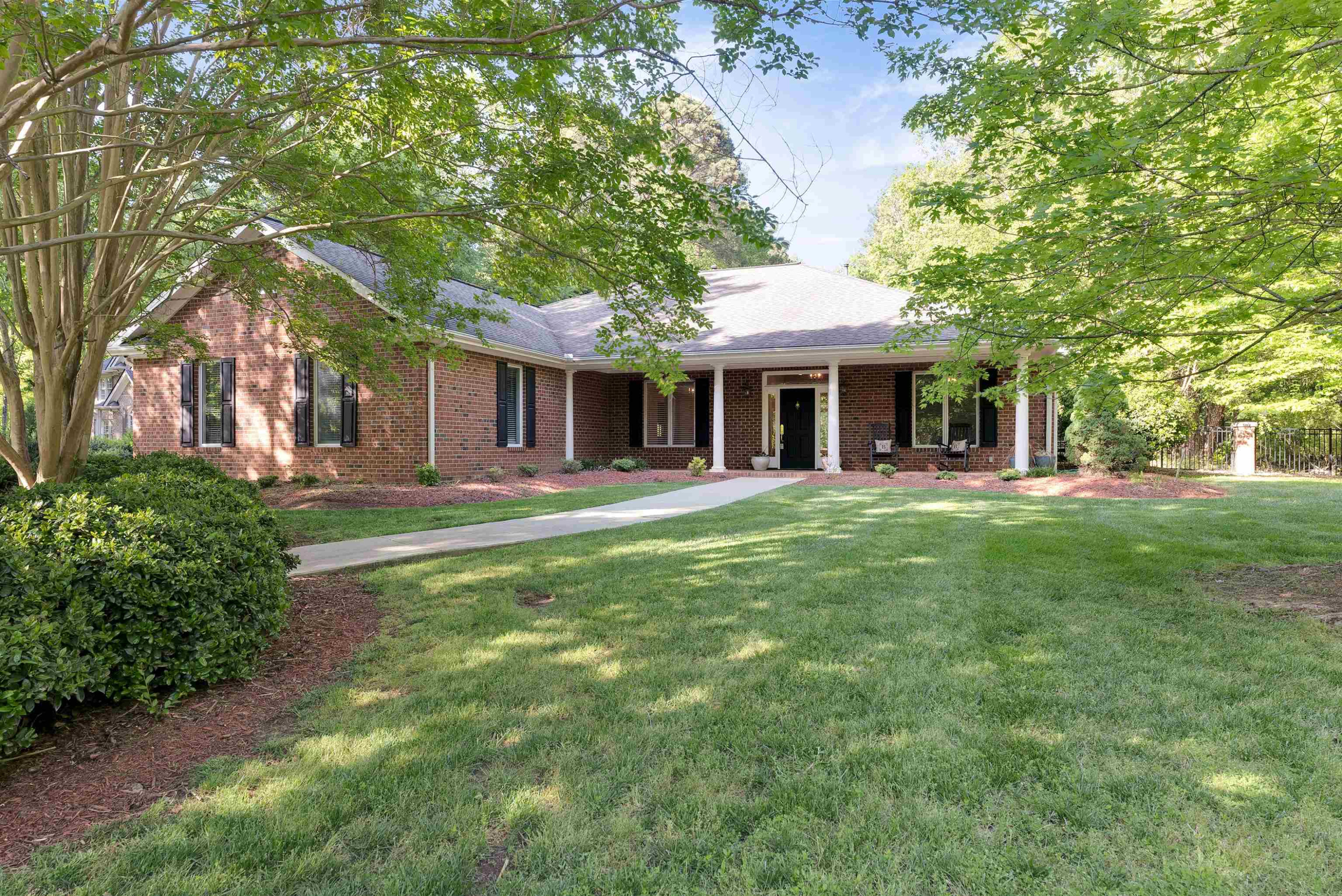 5204 Strathmore Drive Raleigh, NC 27613 - Photo 1 of 32 a front view of a house with a yard table and chairs