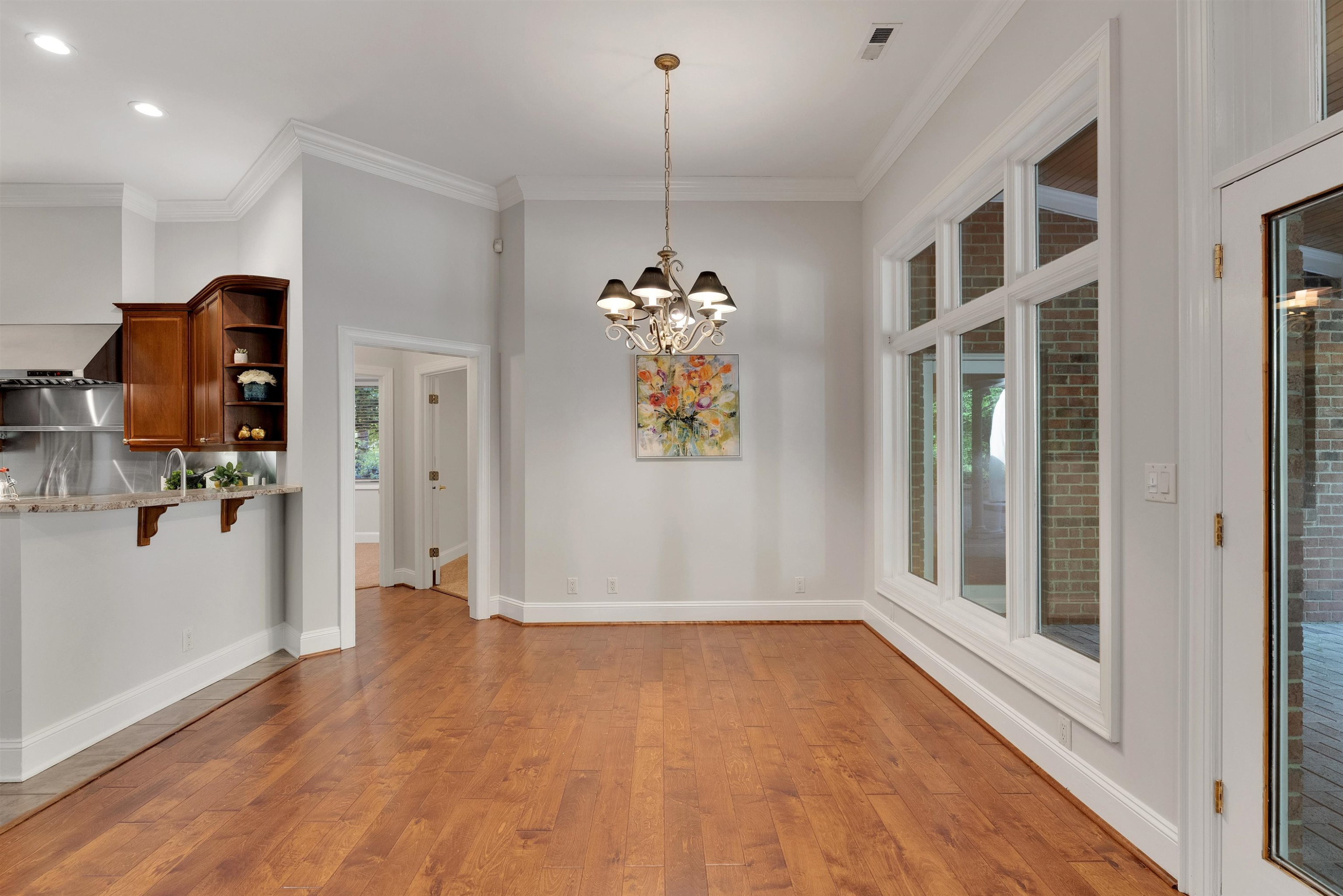 5204 Strathmore Drive Raleigh, NC 27613 - Photo 11 of 32 a view of an entryway with wooden floor and a window