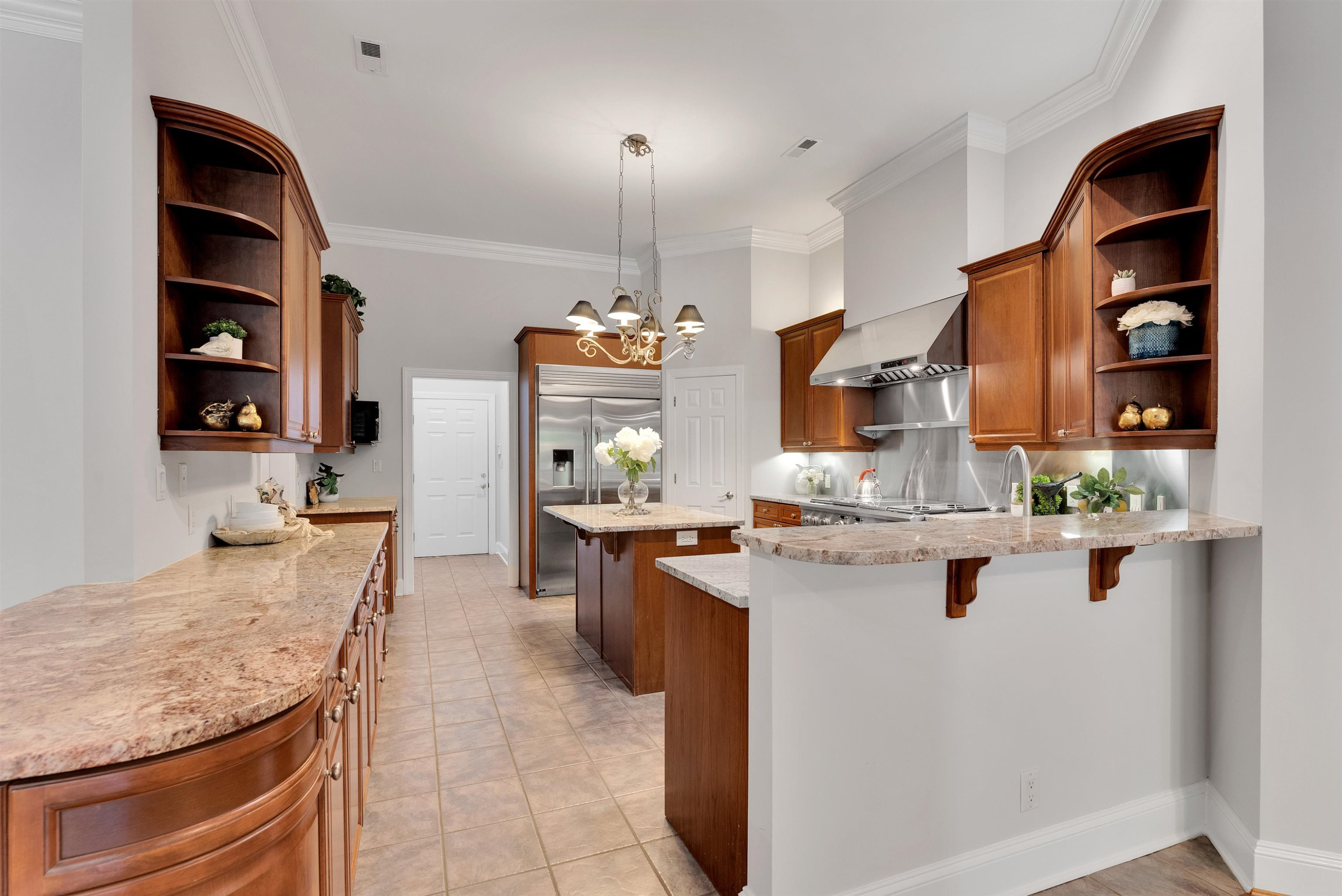 5204 Strathmore Drive Raleigh, NC 27613 - Photo 13 of 32 a kitchen with stainless steel appliances granite countertop sink stove and cabinets