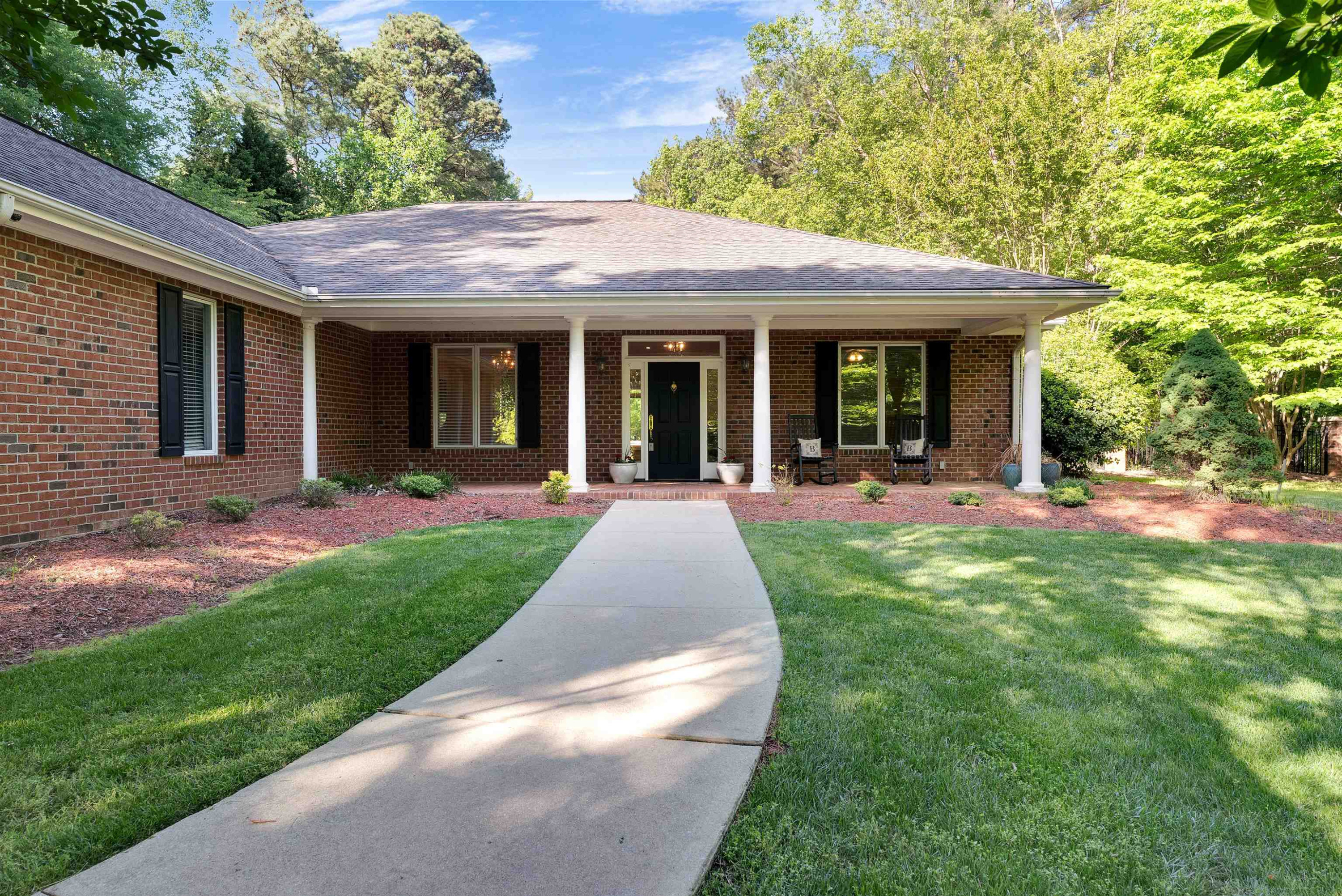 5204 Strathmore Drive Raleigh, NC 27613 - Photo 2 of 32 a view of a house with garden and plants
