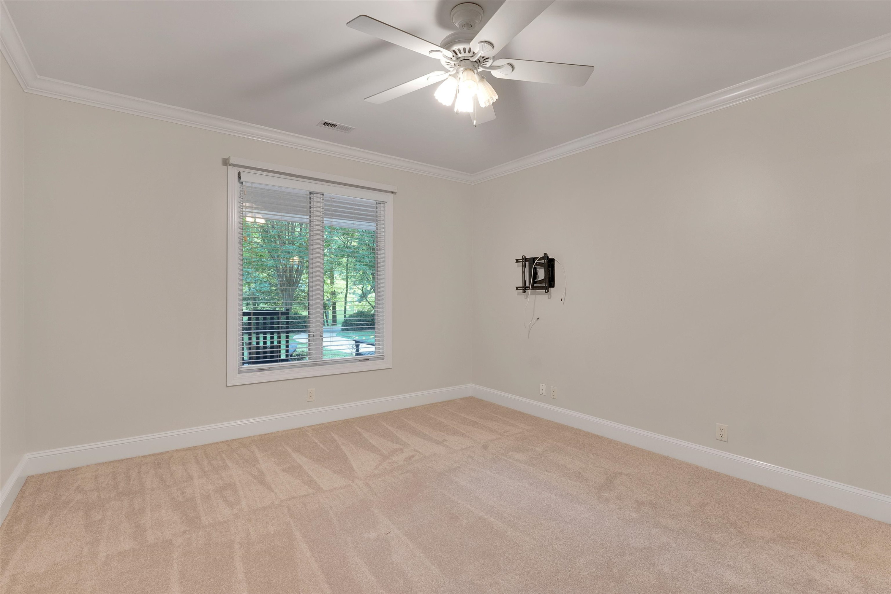 5204 Strathmore Drive Raleigh, NC 27613 - Photo 21 of 32 an empty room with a window and a fan