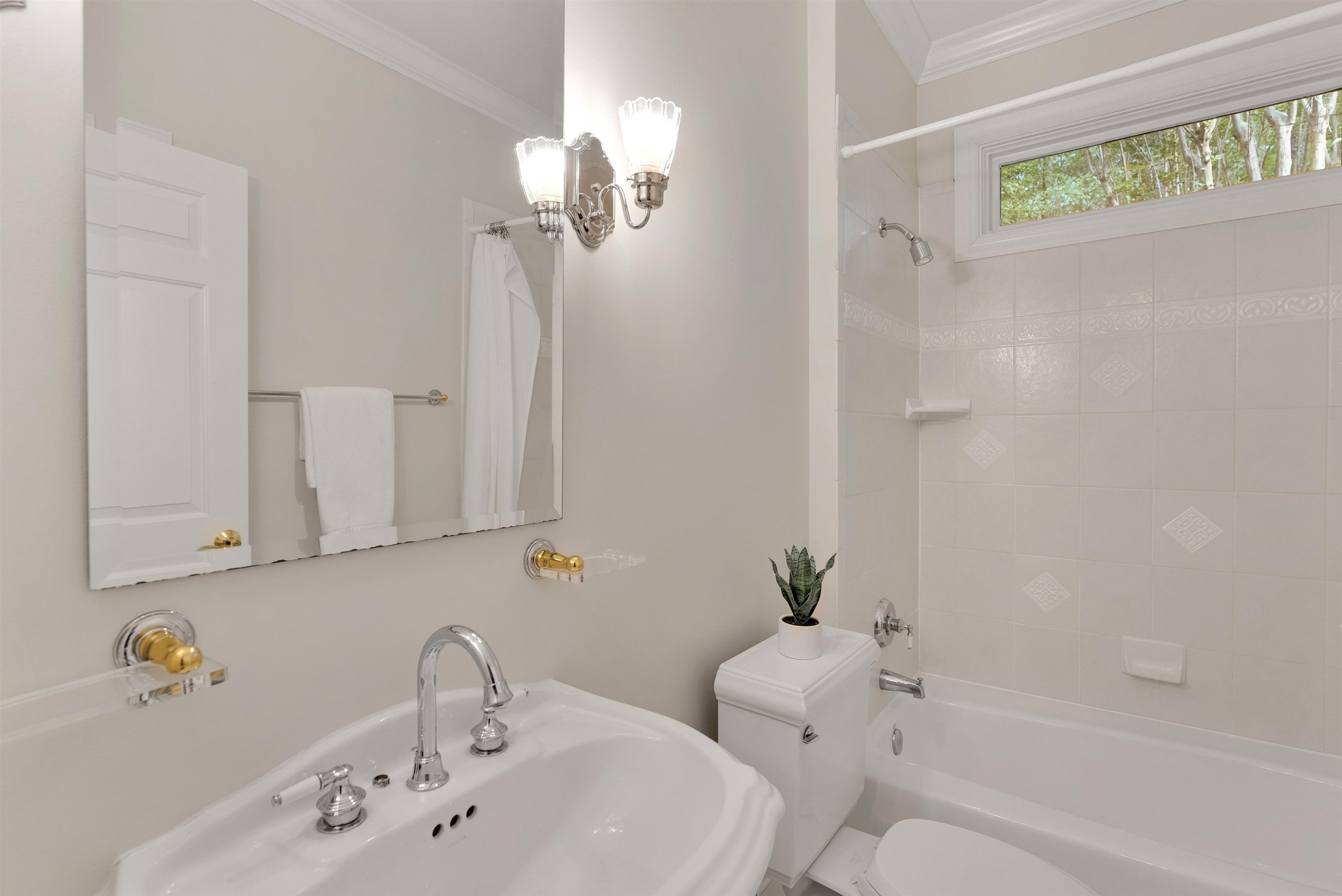 5204 Strathmore Drive Raleigh, NC 27613 - Photo 22 of 32 a bathroom with a sink a toilet and a bathtub