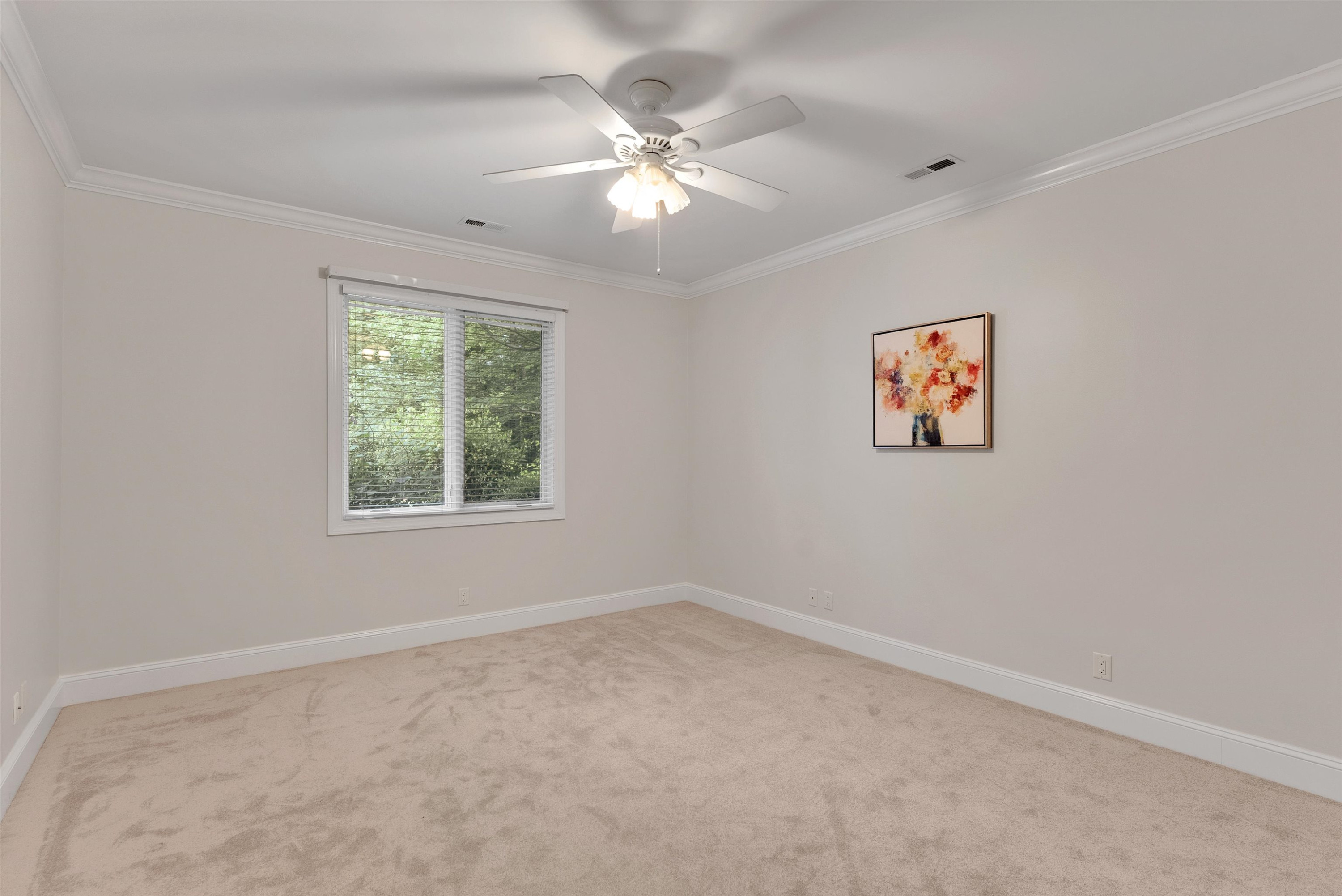 5204 Strathmore Drive Raleigh, NC 27613 - Photo 24 of 32 an empty room with windows and fan