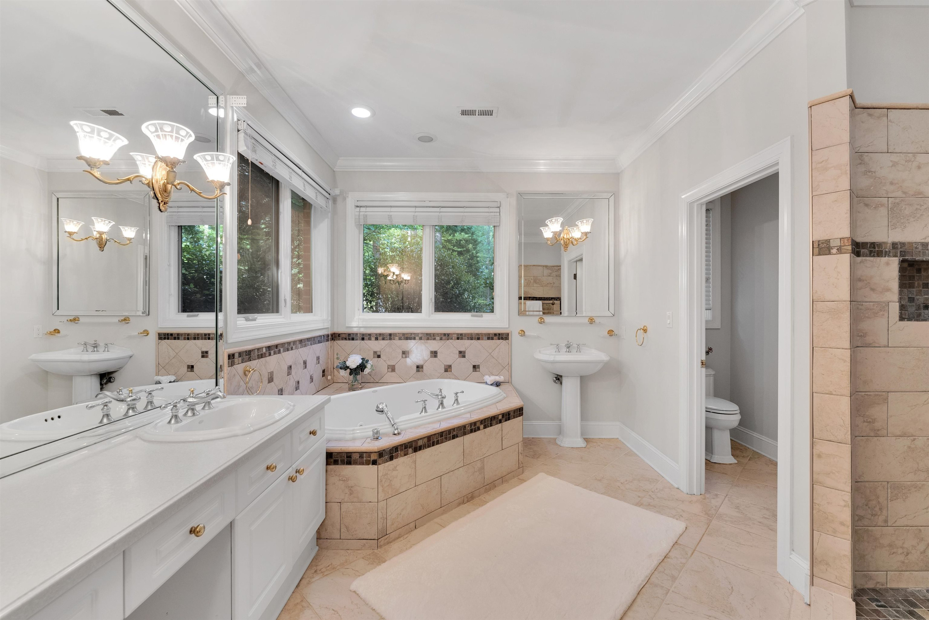 5204 Strathmore Drive Raleigh, NC 27613 - Photo 30 of 32 a large bathroom with a double vanity sink a large mirror and a shower