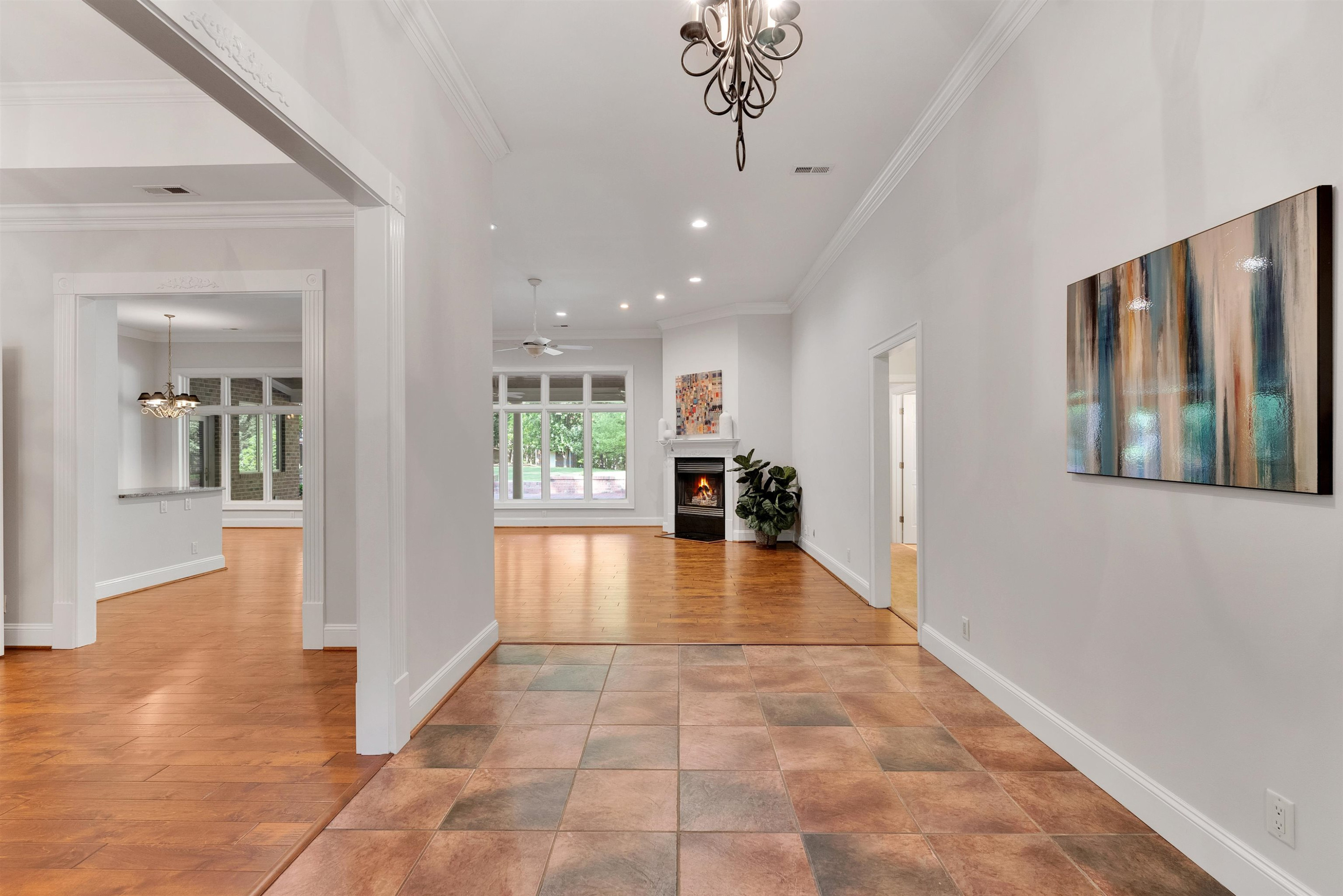 5204 Strathmore Drive Raleigh, NC 27613 - Photo 4 of 32 a view of a hallway with wooden floor and a living room