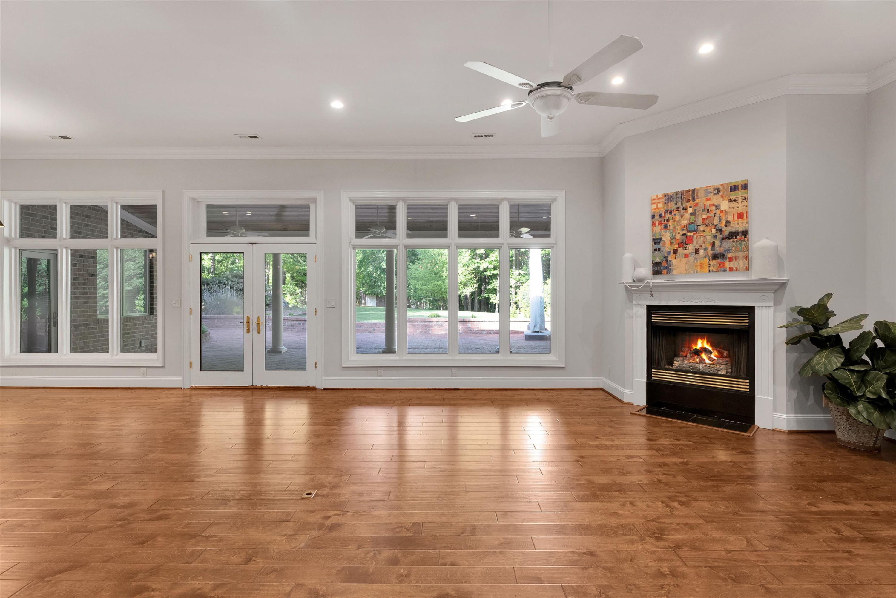 5204 Strathmore Drive Raleigh, NC 27613 - Photo 8 of 32 a view of an empty room with wooden floor and a fireplace