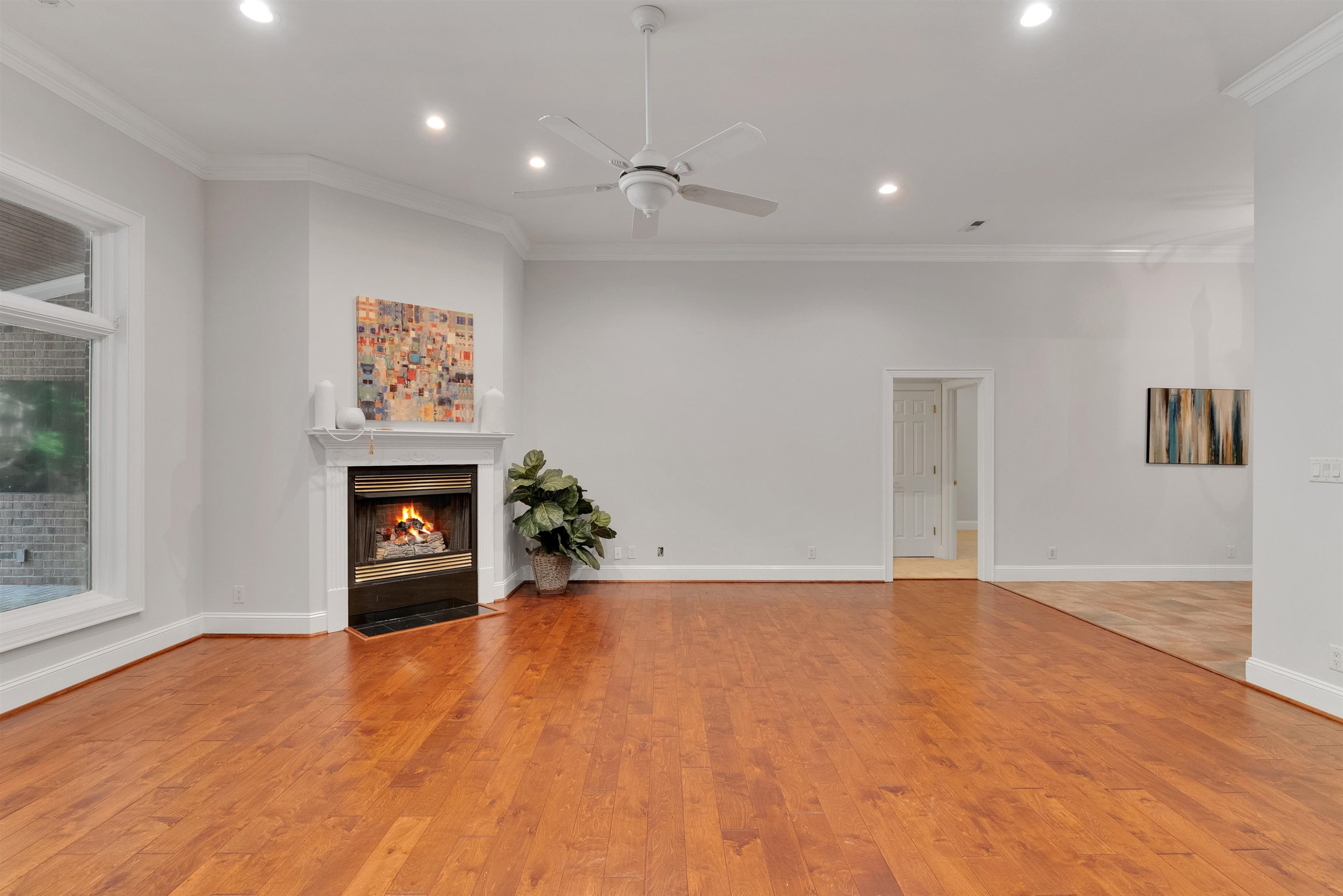 5204 Strathmore Drive Raleigh, NC 27613 - Photo 9 of 32 a view of an empty room with a window and fireplace