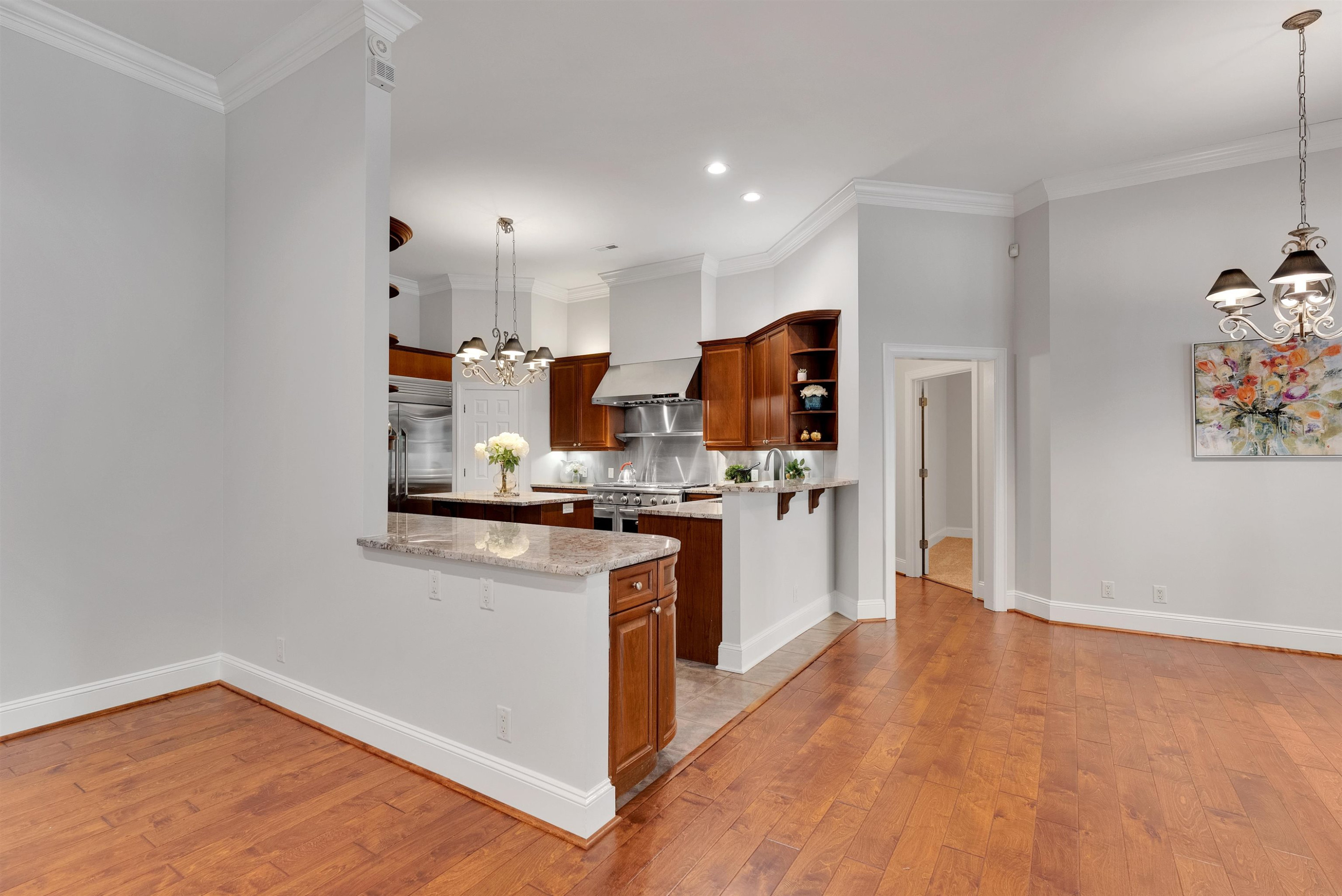 5204 Strathmore Drive Raleigh, NC 27613 - Photo 10 of 32 a kitchen with cabinets and wooden floor