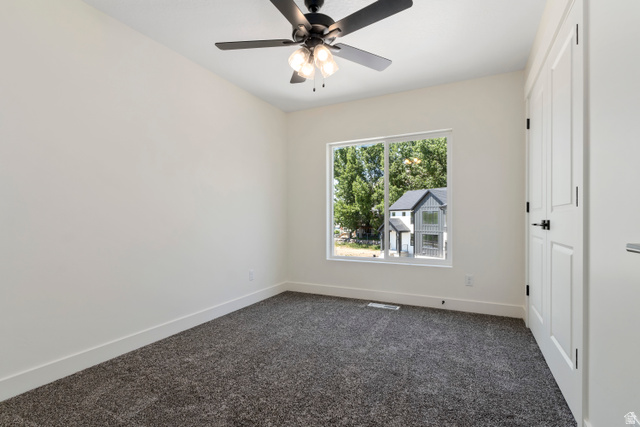 504 North 650 E Street Springville, UT 84663 - Photo 24 of 36 Bedroom featuring a window, gray textured carpeting, and a black ceiling fan with integrated lighting