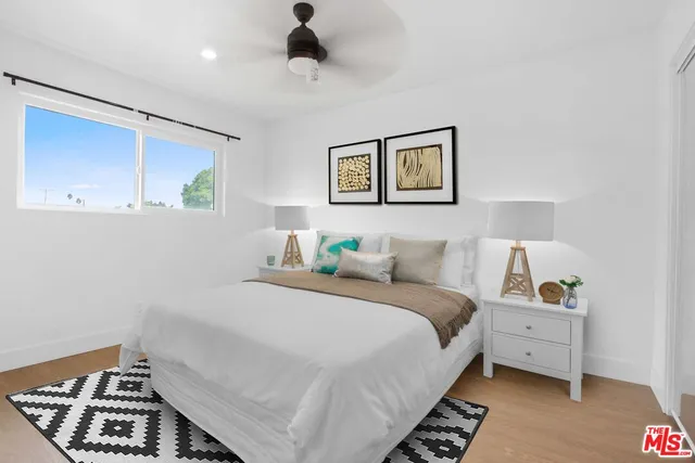 a bedroom with a bed and a painting on the wall