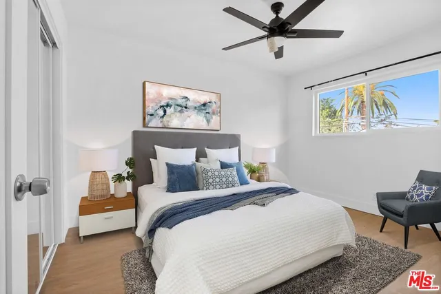 a bedroom with a bed and a painting on the wall