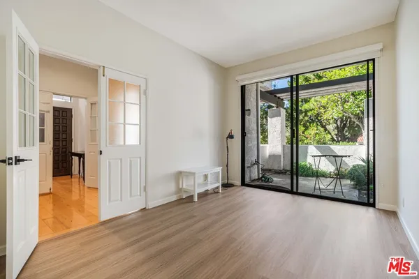 a view of a room with wooden floor and a window