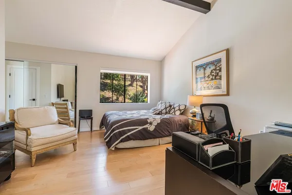 a bedroom with furniture and a window