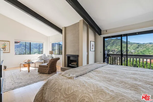 a bedroom with a large bed and a large window