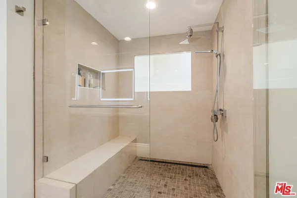 a bathroom with a bathtub and a shower