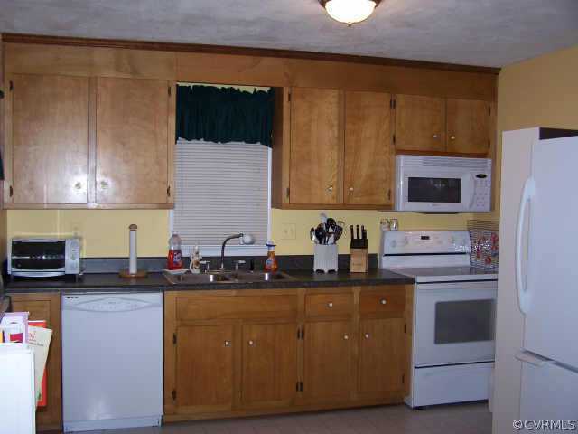 1430 Oldbury Road Midlothian, VA 23113 - Photo 4 of 10 a kitchen with stainless steel appliances granite countertop a sink a stove a microwave a refrigerator and cabinets