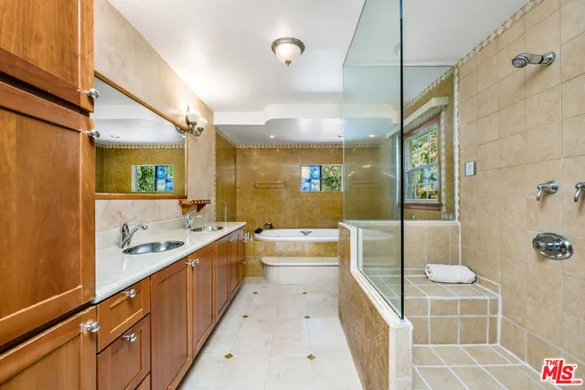 a large bathroom with a tub shower and sink