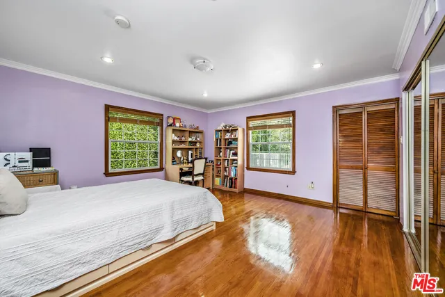 a spacious bedroom with a large bed and a window