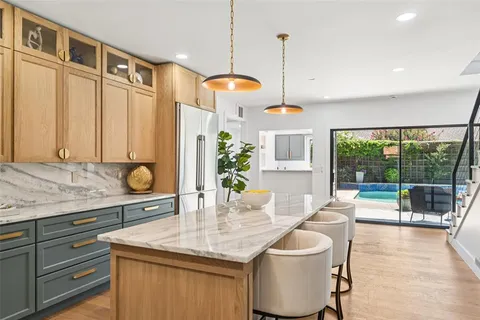 a kitchen with a table and chairs