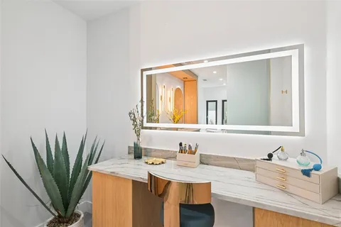 a bathroom with a granite countertop sink a mirror and a