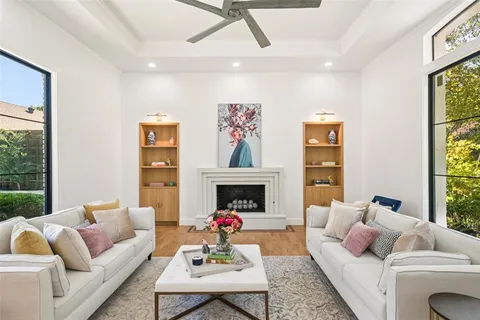 a living room with furniture fireplace and a large window