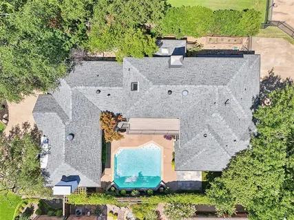 an aerial view of a house with yard