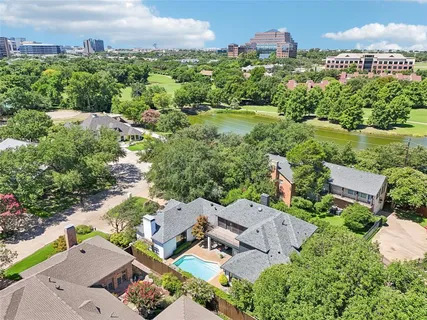 an aerial view of a house with a garden and lake view