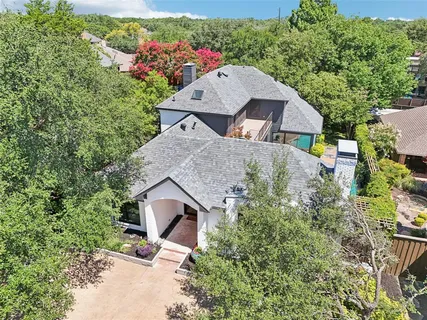 an aerial view of a house with yard and outdoor seating