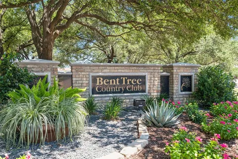 a sign that is in front of flowers