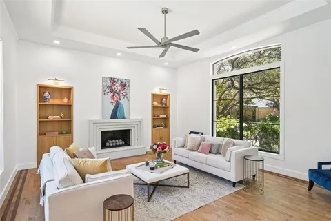 a living room with furniture fireplace and a large window