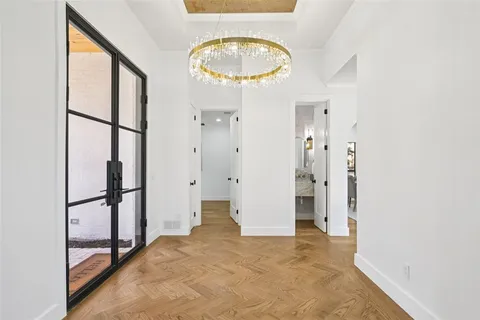 wooden floor in an entryway with a glass door