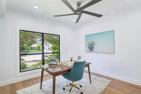 a view of a workspace with furniture and a window