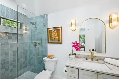 a bathroom with a sink mirror and toilet