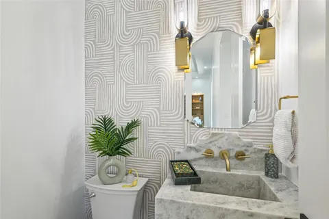 a bath room with a sink and a mirror